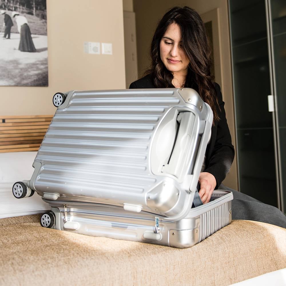 A woman packing her luggage for travel